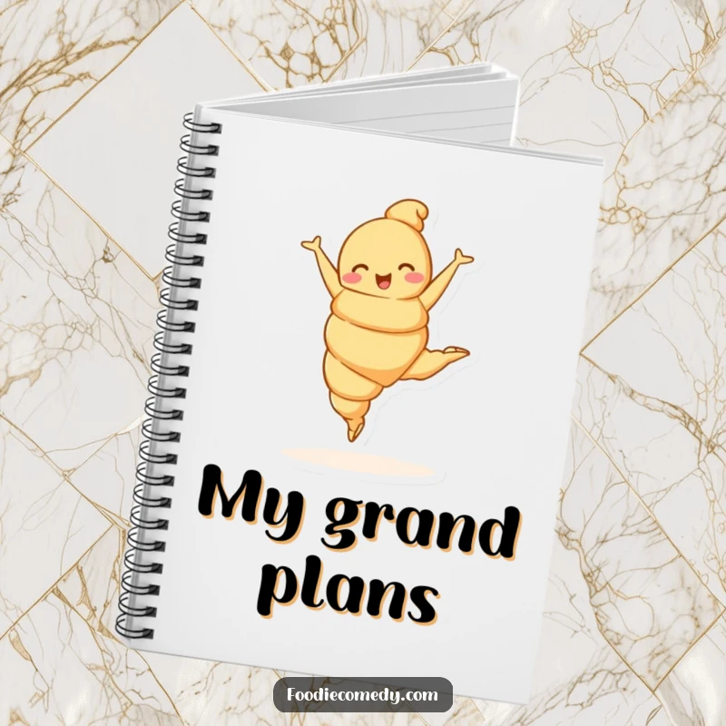 Funny croissant character in a ballet leap on a notebook cover, adding elegant humor to note-taking.